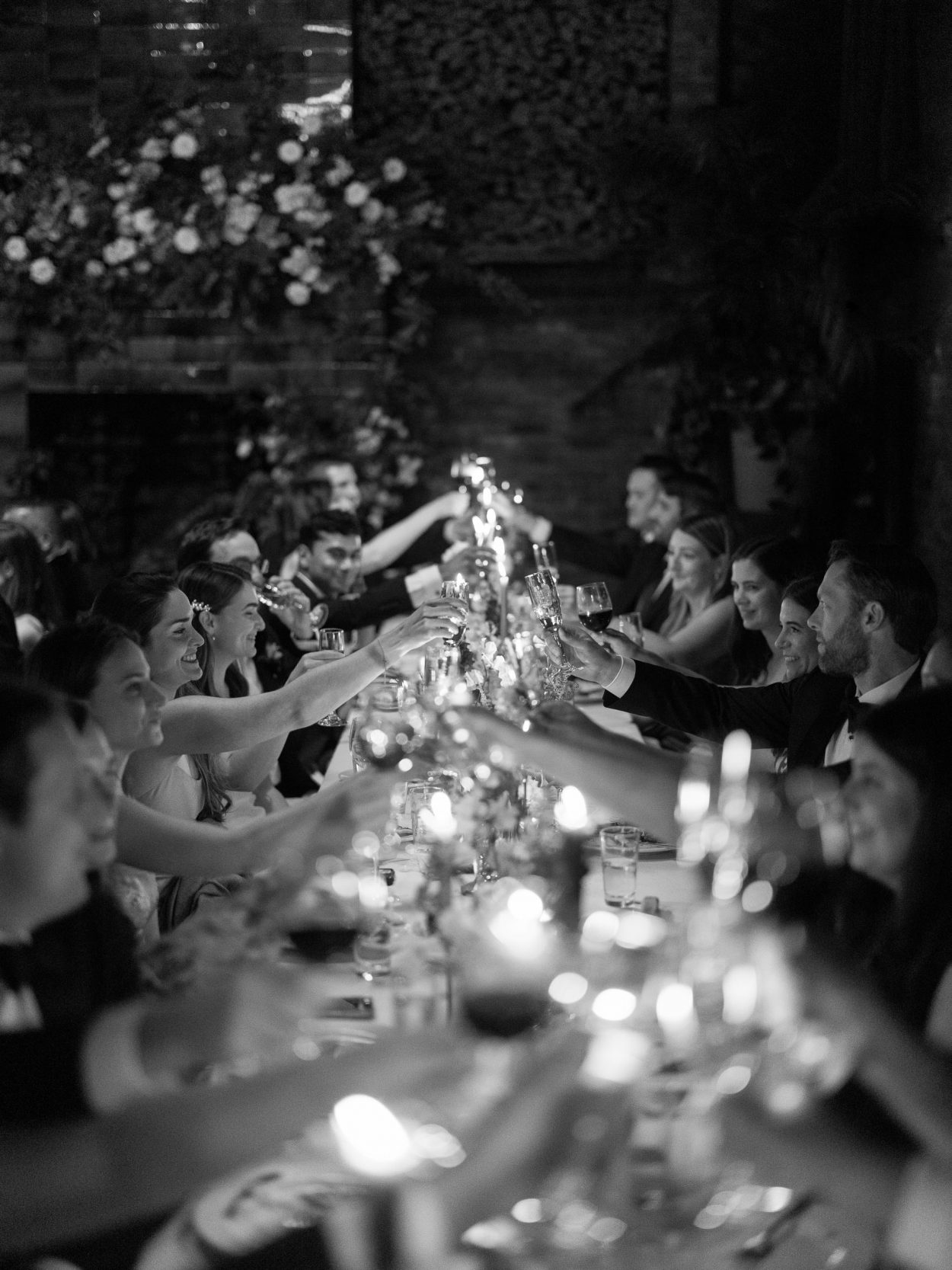 A stylish New York City wedding, rustic brick walls, velvet drapery, and golden candlelight, capturing the intimate, cinematic atmosphere of the iconic venue.