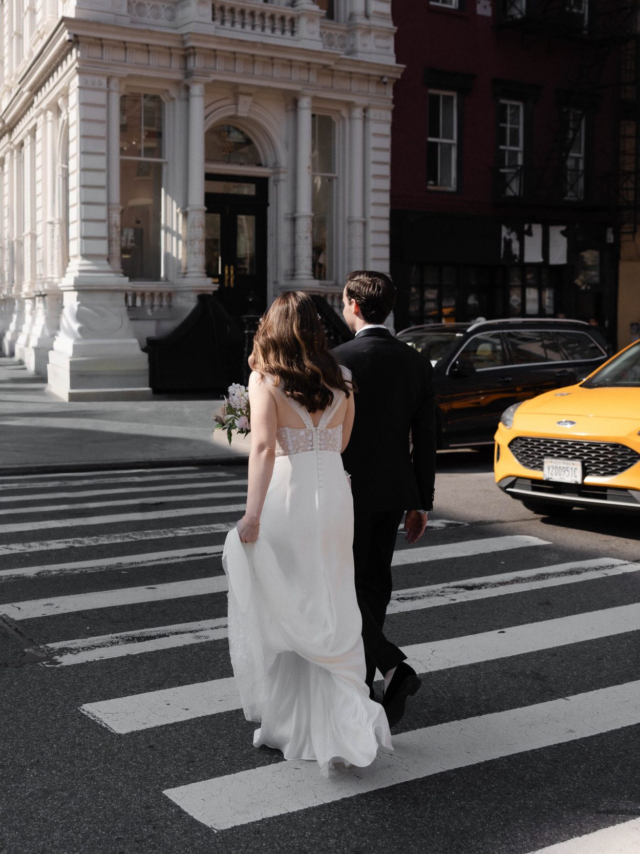 A stylish New York City wedding, rustic brick walls, velvet drapery, and golden candlelight, capturing the intimate, cinematic atmosphere of the iconic venue.