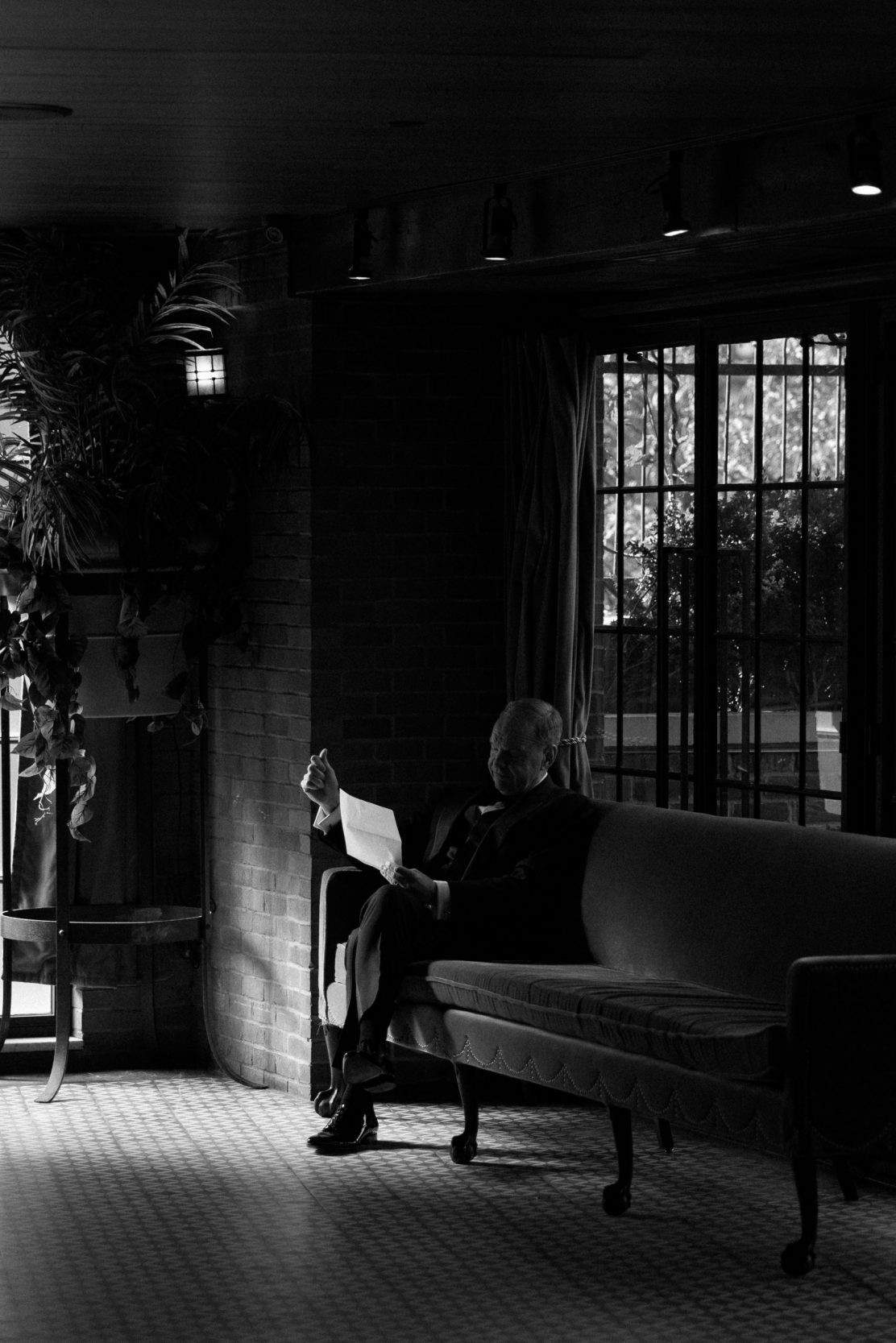 A stylish New York City wedding, rustic brick walls, velvet drapery, and golden candlelight, capturing the intimate, cinematic atmosphere of the iconic venue.