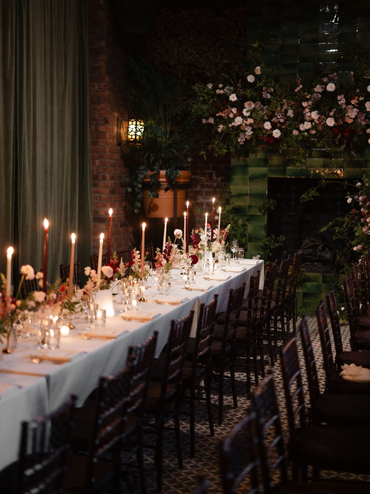 A stylish New York City wedding, rustic brick walls, velvet drapery, and golden candlelight, capturing the intimate, cinematic atmosphere of the iconic venue.