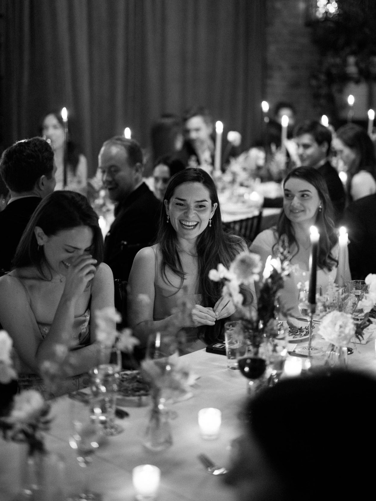 A stylish New York City wedding, rustic brick walls, velvet drapery, and golden candlelight, capturing the intimate, cinematic atmosphere of the iconic venue.