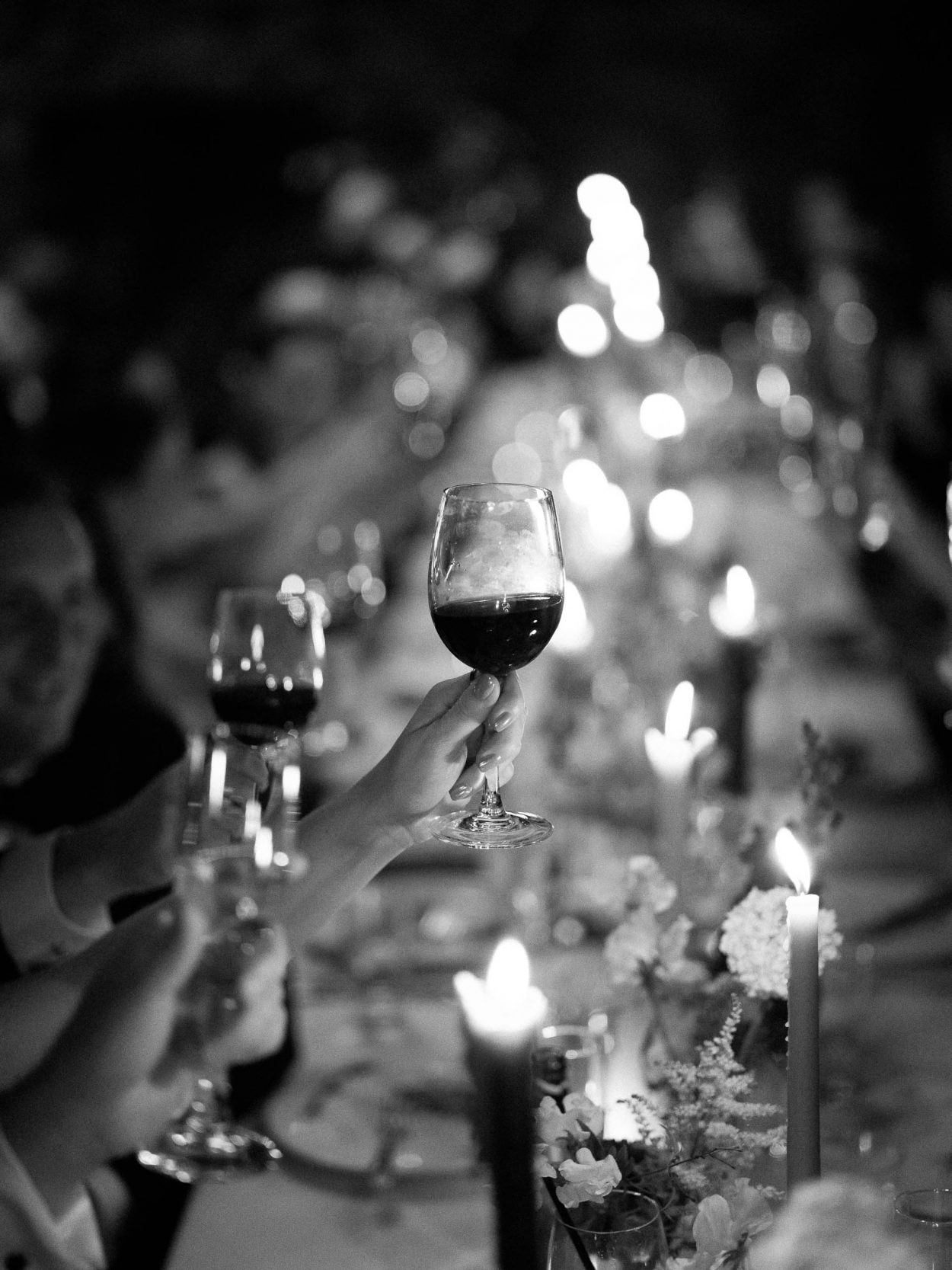 A stylish New York City wedding, rustic brick walls, velvet drapery, and golden candlelight, capturing the intimate, cinematic atmosphere of the iconic venue.