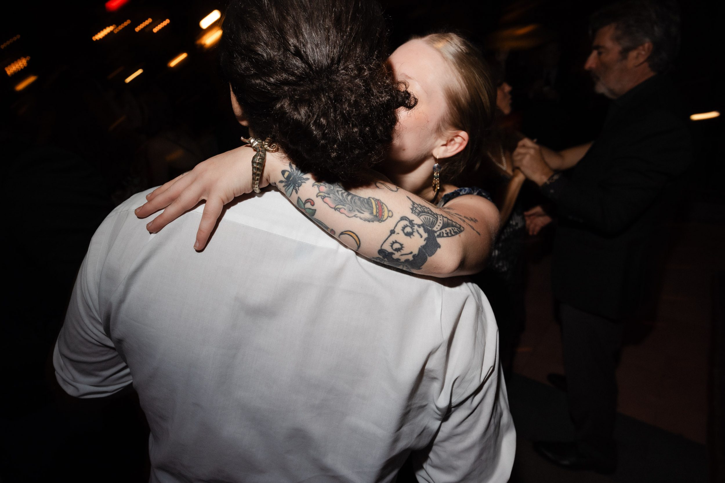 A stylish New York City wedding, rustic brick walls, velvet drapery, and golden candlelight, capturing the intimate, cinematic atmosphere of the iconic venue.