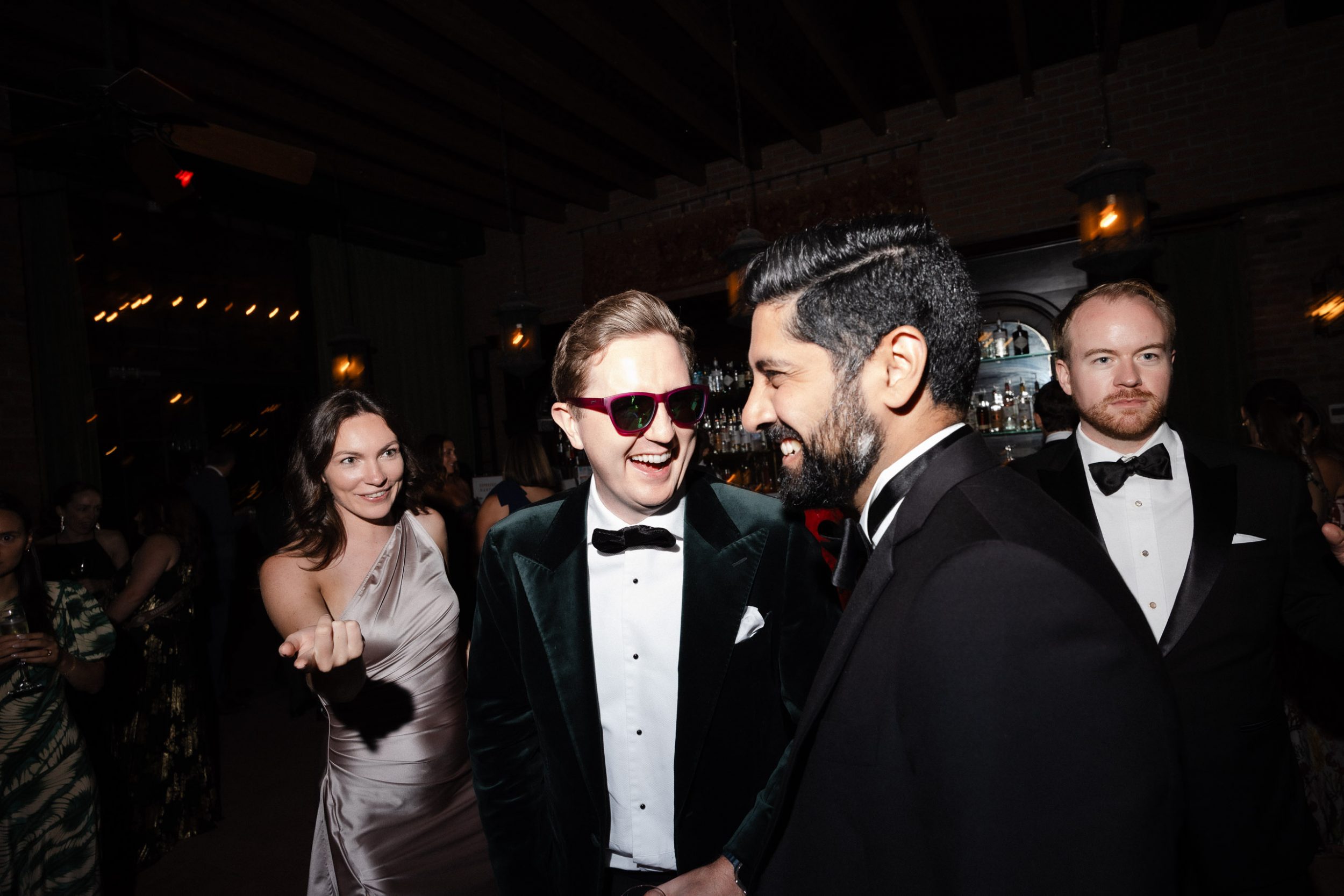 A stylish New York City wedding, rustic brick walls, velvet drapery, and golden candlelight, capturing the intimate, cinematic atmosphere of the iconic venue.