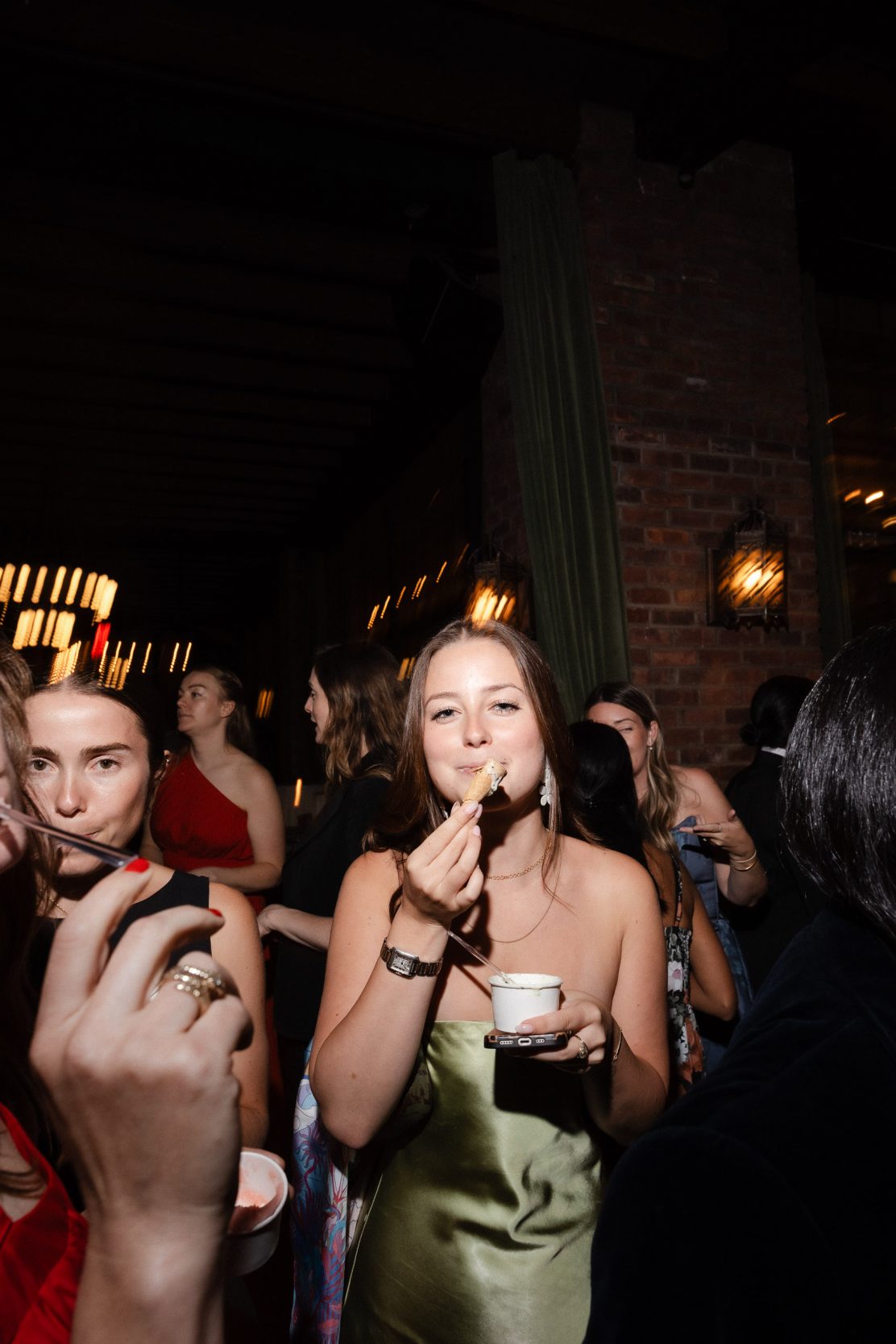 A stylish New York City wedding, rustic brick walls, velvet drapery, and golden candlelight, capturing the intimate, cinematic atmosphere of the iconic venue.