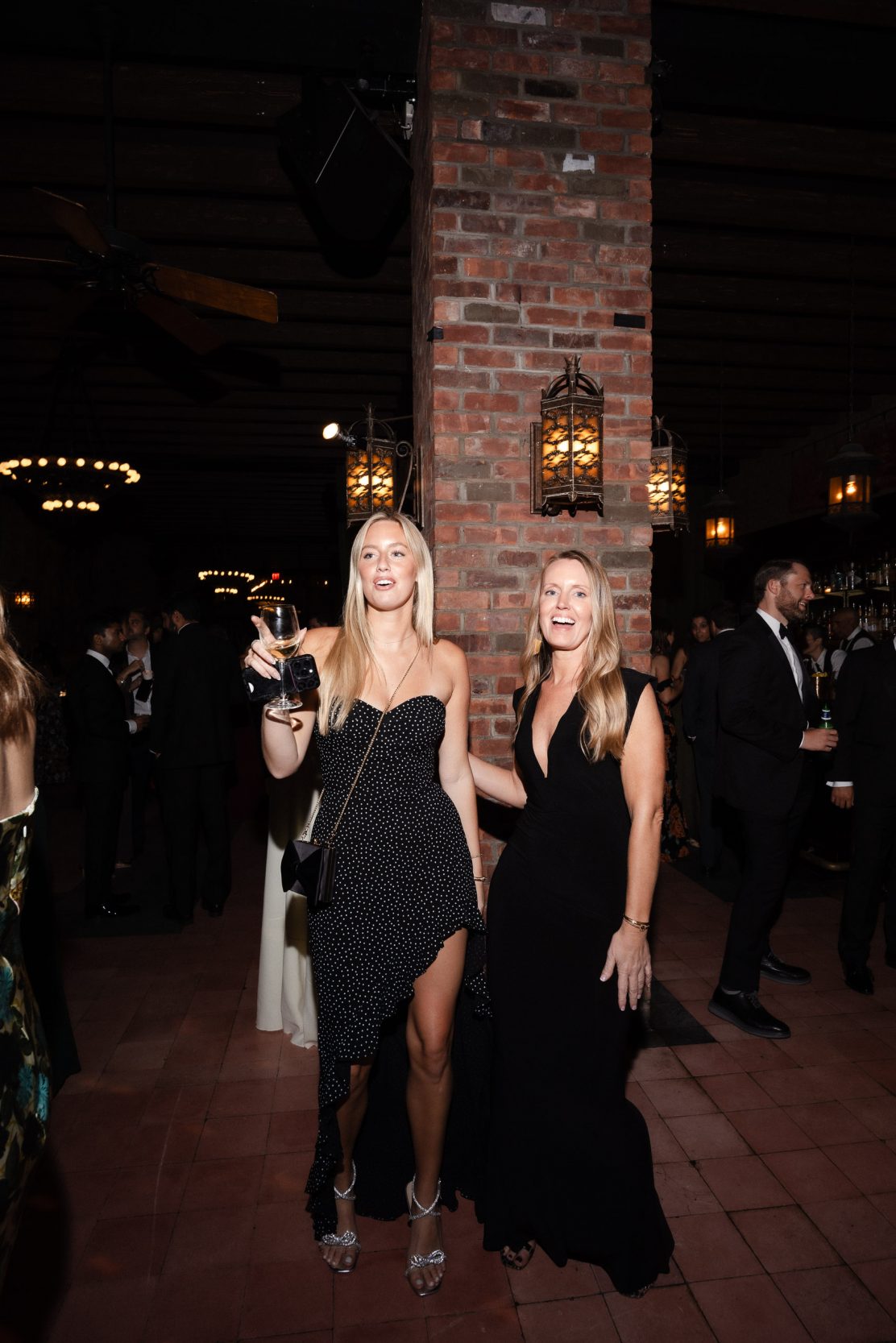 A stylish New York City wedding, rustic brick walls, velvet drapery, and golden candlelight, capturing the intimate, cinematic atmosphere of the iconic venue.