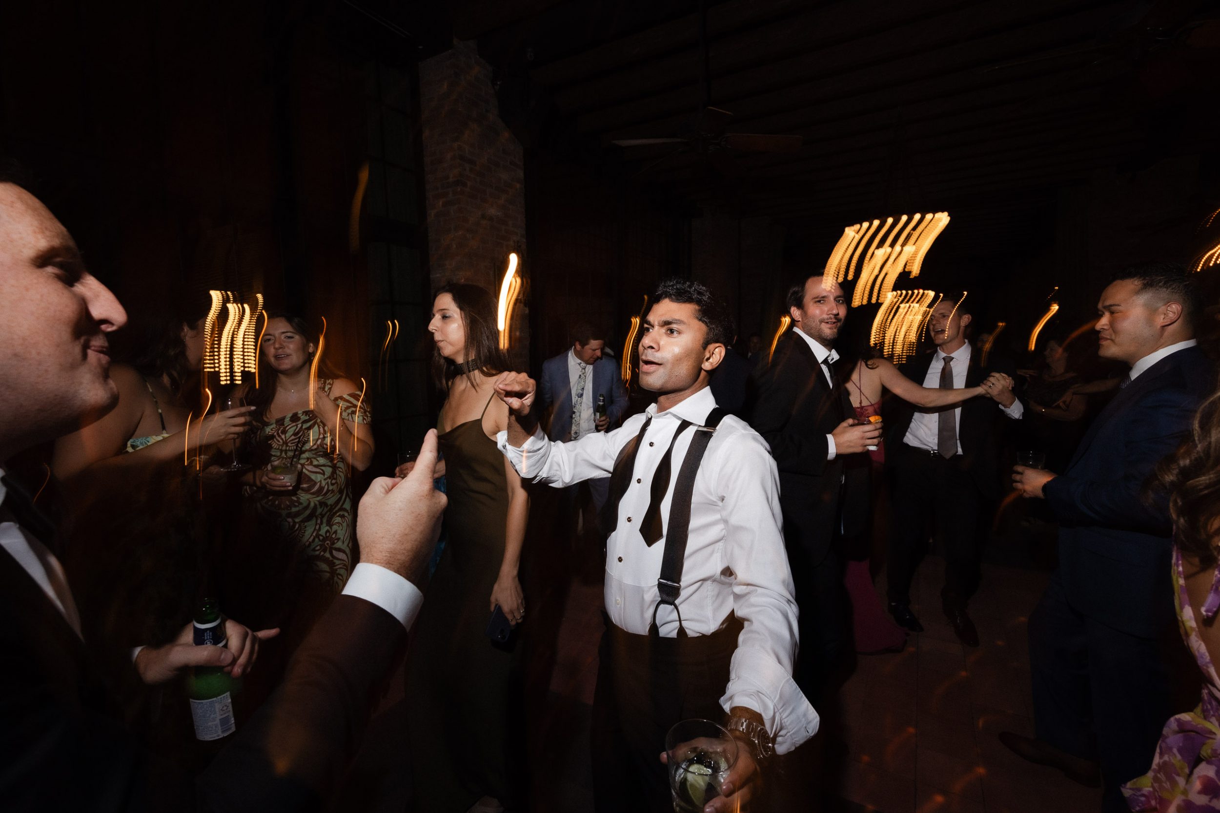 A stylish New York City wedding, rustic brick walls, velvet drapery, and golden candlelight, capturing the intimate, cinematic atmosphere of the iconic venue.