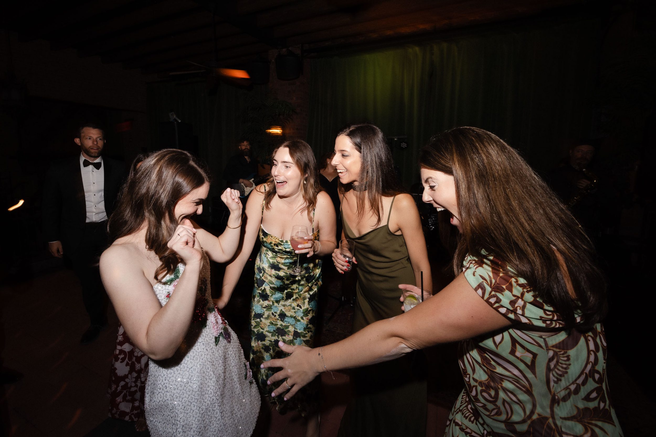 A stylish New York City wedding, rustic brick walls, velvet drapery, and golden candlelight, capturing the intimate, cinematic atmosphere of the iconic venue.